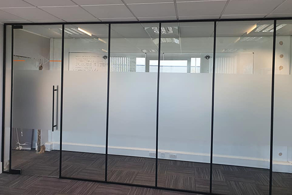 An image of an office window with decorative window film on it.